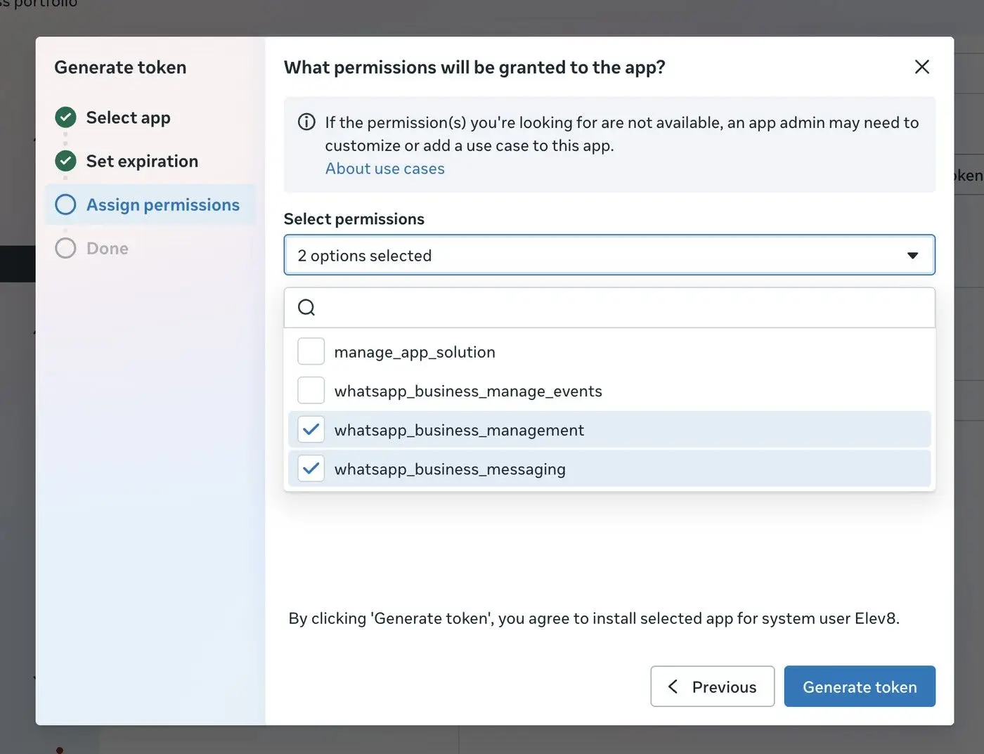 The user is on the 'Assign permissions' step of generating a token. They have selected two permissions: 'whatsapp_business_management' and 'whatsapp_business_messaging'. The user can proceed to generate the token or go back to the previous step.